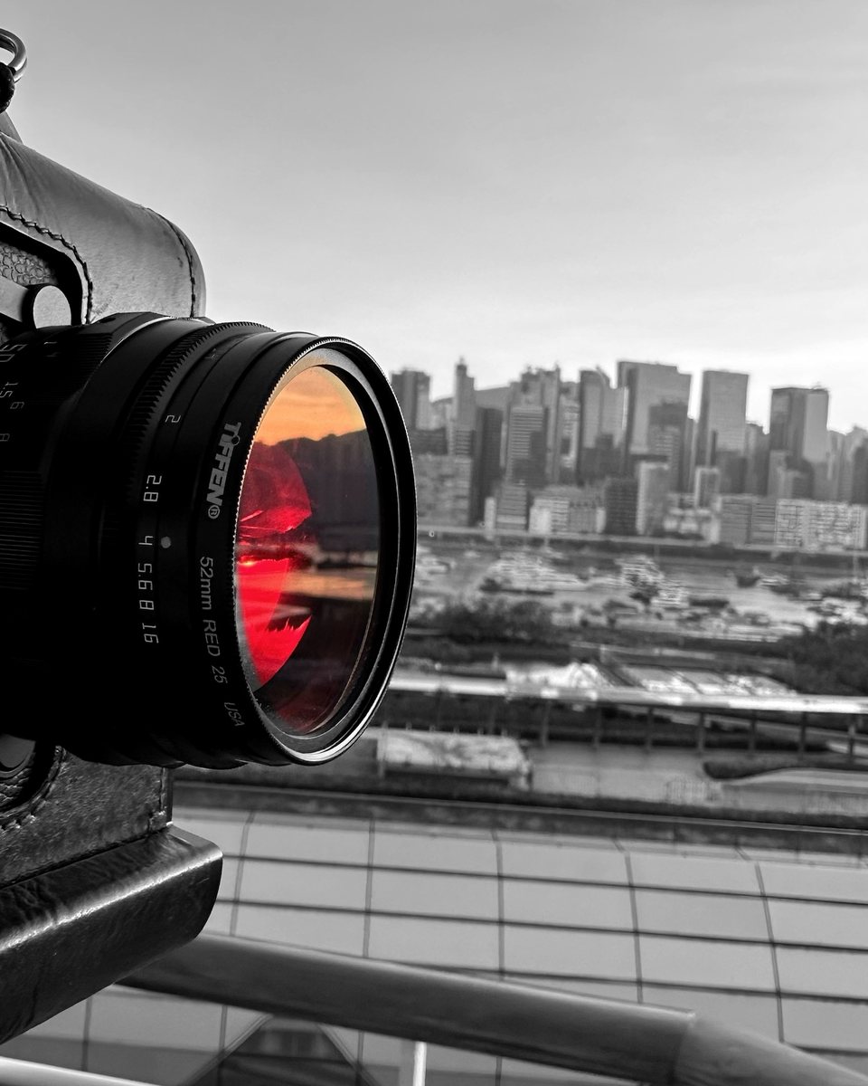 A Tiffen 52mm Red 25 filter on a Leica lens, Hong Kong harbour in black and white with only the red glass in colour